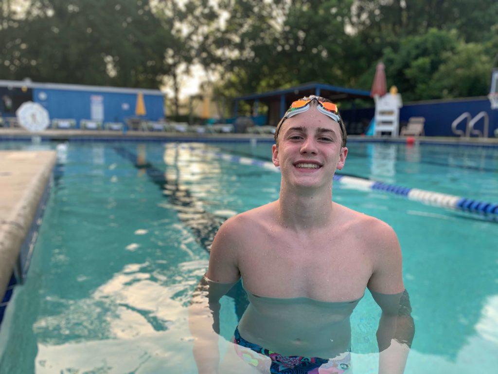 Man smiling in pool.