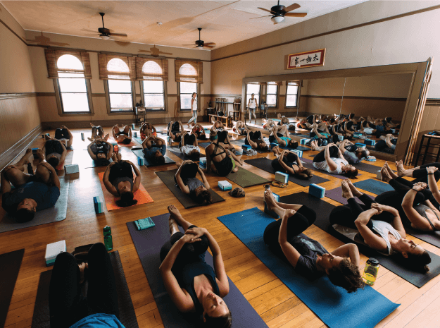 Group of people enjoying a yoga class.