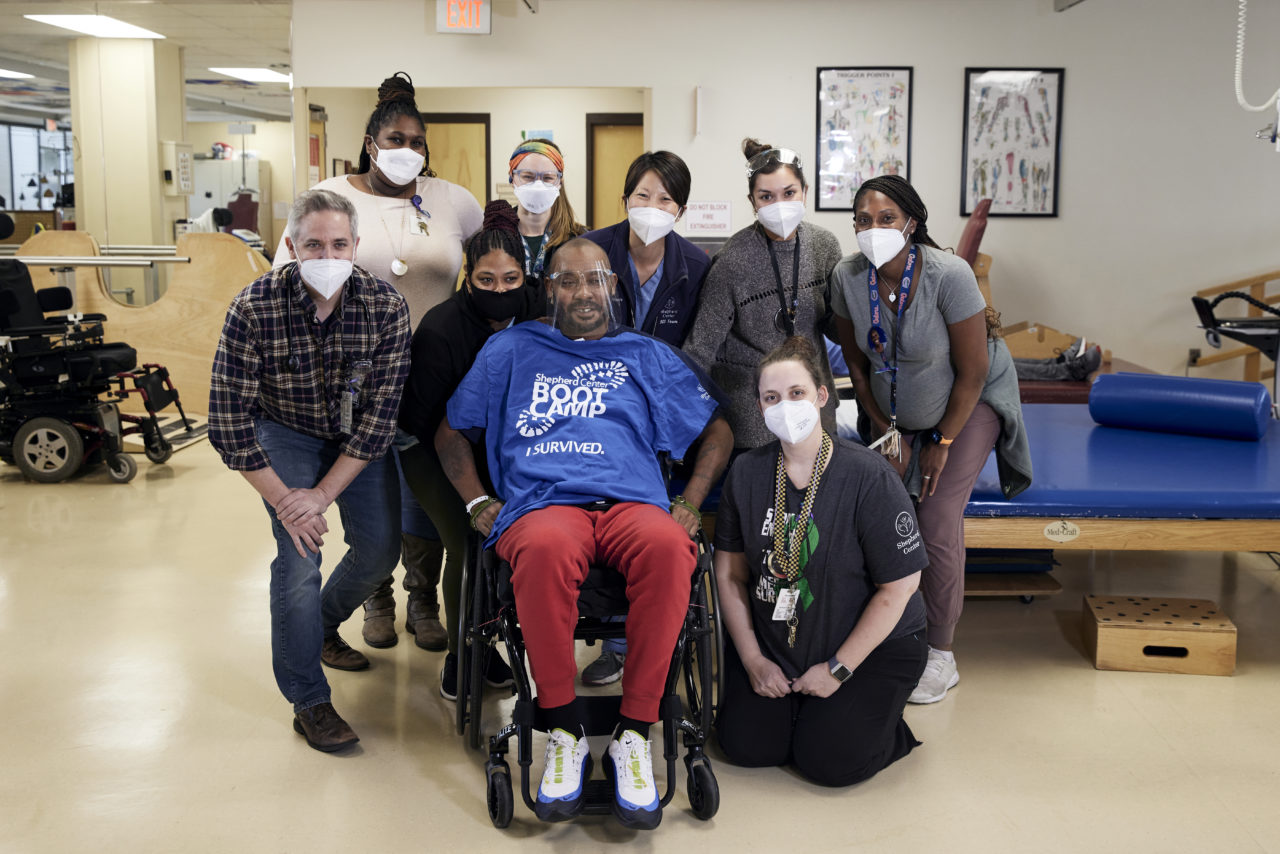 Group of Shepherd Center staff members smiling with patient