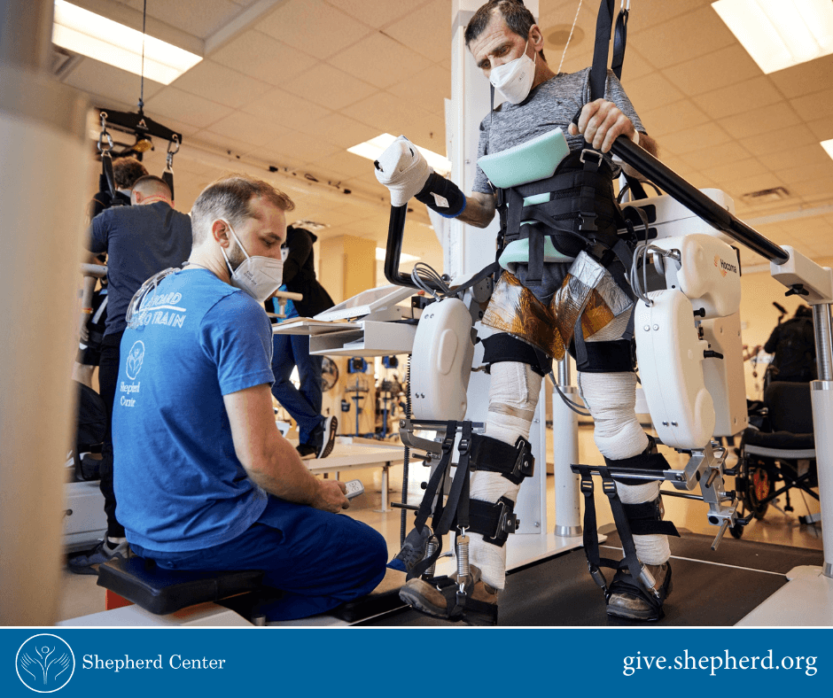 Shepherd patient using using standing mobility device.