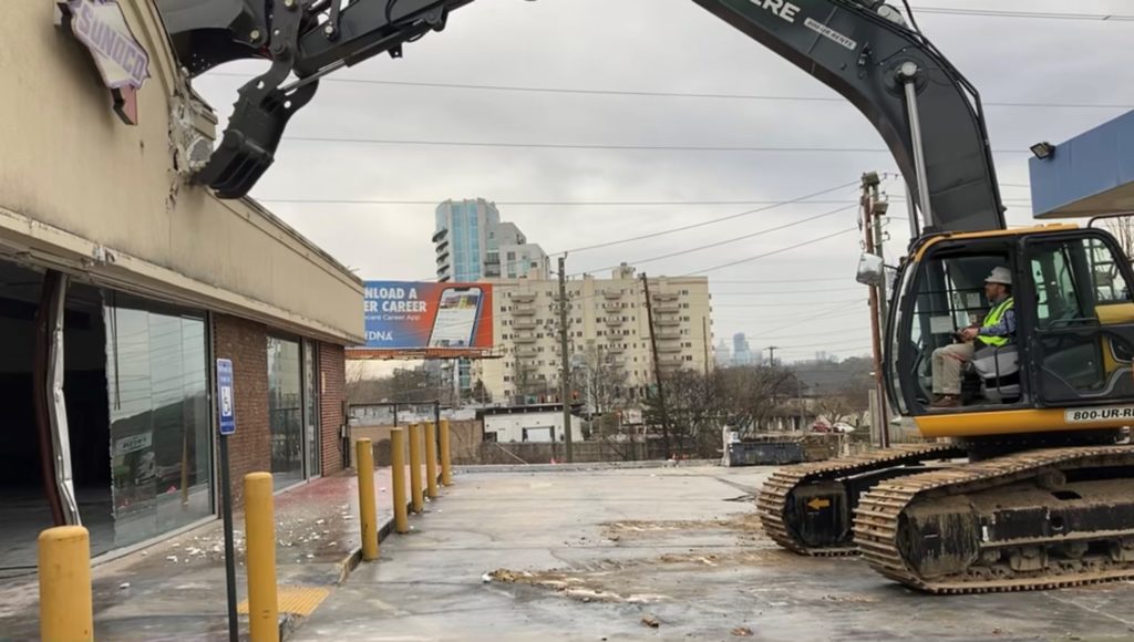 Jamie Shepherd starts the demo of the Sunoco gas station which marks the official beginning of the construction for the new Marcus Center for Advanced Rehabilitation.