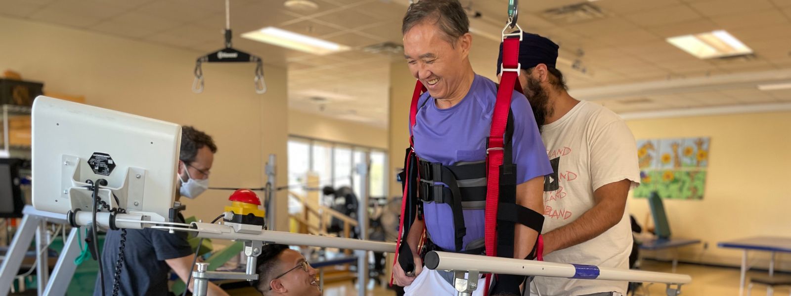 Bobby Kwak, a patient at Shepherd Center, uses a robotic rehabilitation device with the help of his physical therapists to increase muscle strength and range of motion in his legs after sustaining a spinal cord injury.